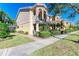 Two-story townhome with attractive landscaping and a brick walkway at 7879 Bergamo Ave, Sarasota, FL 34238