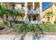 Front view of townhouse with lush landscaping and private entrance at 7879 Bergamo Ave, Sarasota, FL 34238