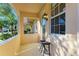 Front porch with wrought iron gate and two black stools at 7879 Bergamo Ave, Sarasota, FL 34238