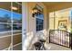 Front porch with wrought iron gate and two black stools at 7879 Bergamo Ave, Sarasota, FL 34238