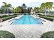 Community lap pool with plenty of lounge chairs at 7879 Bergamo Ave, Sarasota, FL 34238