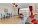 Bright living room with tiled floors, comfy seating, and access to a patio at 7879 Bergamo Ave, Sarasota, FL 34238