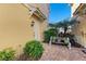 Private patio with brick pavers, greenery, and a quaint bench at 7879 Bergamo Ave, Sarasota, FL 34238