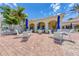 Community patio area with tables, chairs, and blue umbrellas at 7879 Bergamo Ave, Sarasota, FL 34238