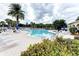 Freeform community pool with ample lounge chairs and umbrellas at 7879 Bergamo Ave, Sarasota, FL 34238