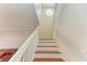 Staircase with wood steps and white railings leading to the second floor at 7879 Bergamo Ave, Sarasota, FL 34238