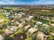 Aerial view of upscale community with golf course and various houses at 804 Connemara Cir, Venice, FL 34292