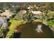 Aerial view of community with lake, fountain, and houses with pools at 804 Connemara Cir, Venice, FL 34292