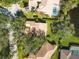 Aerial view of single Gathering home with pool, lush landscaping, and nearby lake at 804 Connemara Cir, Venice, FL 34292