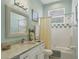 Clean bathroom with white cabinets and a shower/tub combo at 804 Connemara Cir, Venice, FL 34292