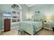 Light and airy bedroom with a queen-size bed and wood-look floors at 804 Connemara Cir, Venice, FL 34292