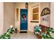 Welcoming front porch with blue door and decorative wreath at 804 Connemara Cir, Venice, FL 34292