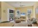 Spacious living room featuring a comfy sofa, a chaise lounge, and sliding doors to the patio at 804 Connemara Cir, Venice, FL 34292