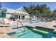 Community pool and spa with lounge chairs and a clubhouse at 804 Connemara Cir, Venice, FL 34292