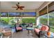 Bright screened porch with comfortable seating and a view at 804 Connemara Cir, Venice, FL 34292