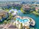 Aerial view of community pool, lake, and resort-style amenities at 8335 38Th Street E Cir # 303, Sarasota, FL 34243