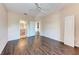 Bedroom with wood floors, ceiling fan, and access to bathroom at 8335 38Th Street E Cir # 303, Sarasota, FL 34243