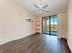 Bedroom with wood-look floors, balcony access, and ceiling fan at 8335 38Th Street E Cir # 303, Sarasota, FL 34243