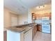 Kitchen with wood cabinets, granite countertops, and white appliances at 8335 38Th Street E Cir # 303, Sarasota, FL 34243