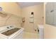 Laundry room with washer, dryer, and shelving at 8335 38Th Street E Cir # 303, Sarasota, FL 34243