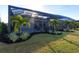 Landscaped backyard with a screened-in patio and lush tropical plants at 8497 Pavia Way, Bradenton, FL 34202