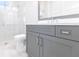 Gray vanity with a quartz countertop and a shower stall at 8497 Pavia Way, Bradenton, FL 34202