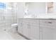 Bathroom with white vanity, quartz countertop, and shower at 8497 Pavia Way, Bradenton, FL 34202