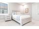 Bright bedroom with white bed frame and light gray walls at 8497 Pavia Way, Bradenton, FL 34202