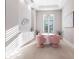 Bright dining room with pink chairs and white table at 8497 Pavia Way, Bradenton, FL 34202