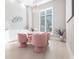 Bright dining room with pink chairs and white table at 8497 Pavia Way, Bradenton, FL 34202