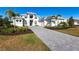 Two-story home with paver driveway & palm trees at 8497 Pavia Way, Bradenton, FL 34202