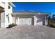 Three-car garage with light-colored doors at 8497 Pavia Way, Bradenton, FL 34202