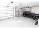 Spacious two-car garage with epoxy flooring and ample storage space at 8497 Pavia Way, Bradenton, FL 34202