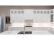 Modern kitchen with white cabinets and marble countertops at 8497 Pavia Way, Bradenton, FL 34202