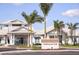 Exterior view of the Driftwood Club with palm trees enhancing the curb appeal of this luxury community at 9405 Ballaster Pointe Loop, Parrish, FL 34219