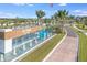 Welcoming community entrance with water feature and signage at Del Webb BayView, surrounded by lush landscaping at 9405 Ballaster Pointe Loop, Parrish, FL 34219