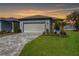 Single-story home with a paved driveway and landscaped yard at 9405 Ballaster Pointe Loop, Parrish, FL 34219