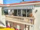 Covered balcony with striped awning and stone balustrade at 1023 Tocobaga Ln, Sarasota, FL 34236