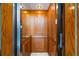 Private elevator with wood paneling and modern controls at 1023 Tocobaga Ln, Sarasota, FL 34236