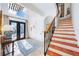 Spacious entryway featuring terracotta tile stairs and iron railing at 1023 Tocobaga Ln, Sarasota, FL 34236