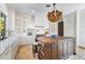 Modern kitchen with white cabinetry and a large center island at 1023 Tocobaga Ln, Sarasota, FL 34236