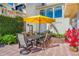 Outdoor patio with dining table and seating under a yellow umbrella at 1023 Tocobaga Ln, Sarasota, FL 34236