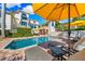 Relaxing pool area with lounge chairs and yellow umbrellas at 1023 Tocobaga Ln, Sarasota, FL 34236