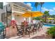 Outdoor dining space near the pool with spiral staircase at 1023 Tocobaga Ln, Sarasota, FL 34236