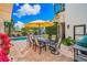 Inviting pool area with patio furniture, umbrella, and grill at 1023 Tocobaga Ln, Sarasota, FL 34236