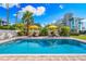 Relaxing pool with patio and two yellow umbrellas at 1023 Tocobaga Ln, Sarasota, FL 34236