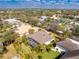 Aerial view of a house surrounded by lush palm trees with a screened-in pool area at 1069 Harbour Cape Pl, Punta Gorda, FL 33983