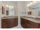 Bathroom featuring double sinks with granite countertops and wood cabinets at 1069 Harbour Cape Pl, Punta Gorda, FL 33983