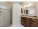 Bathroom featuring a tiled shower and wood cabinets with a granite countertop at 1069 Harbour Cape Pl, Punta Gorda, FL 33983