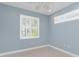 Bedroom with a large window and light blue walls at 1069 Harbour Cape Pl, Punta Gorda, FL 33983